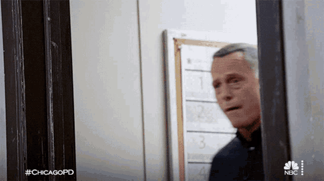 a man is standing in front of a bulletin board with the hashtag #chicagopd on it