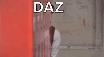 a man in a suit and tie is standing in front of a red wall and a sign that says `` daz you good '' .