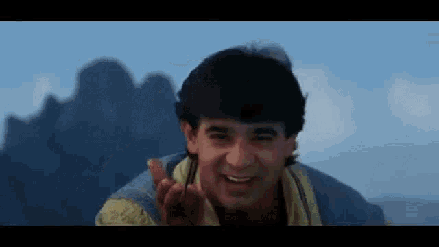 a man is giving the middle finger to the camera while smiling .