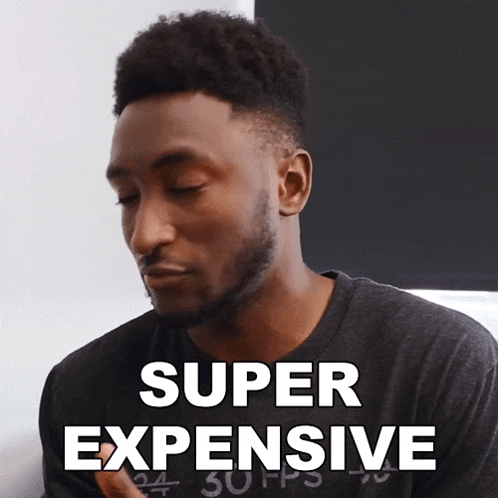 a man wearing a black shirt with the words super expensive written on it