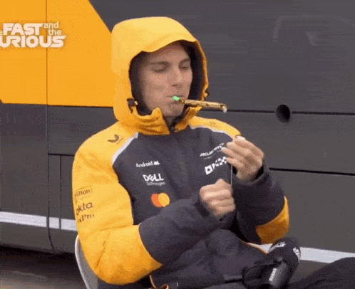 a man wearing a dell jacket is blowing a party horn