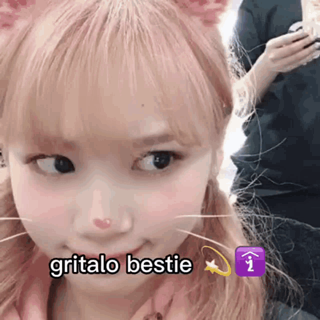 a close up of a girl with cat ears and the words gritalo bestie on her face