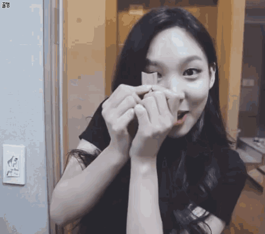 a woman making a heart shape with her hands
