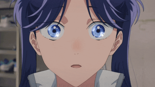 a close up of a girl 's face with a surprised look on her face