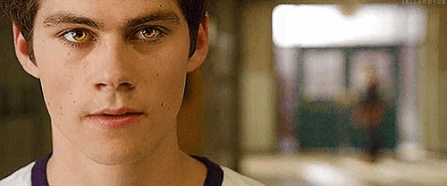 a close up of a young man 's face in a hallway .