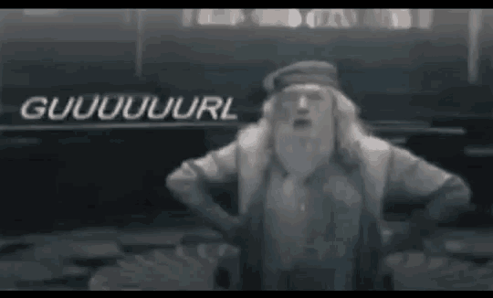 a man with a beard is standing in front of a sign that says guuuuuuuurl .