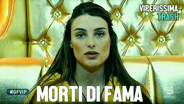 a woman is sitting in front of a gold couch with the words morti di fana written on the bottom