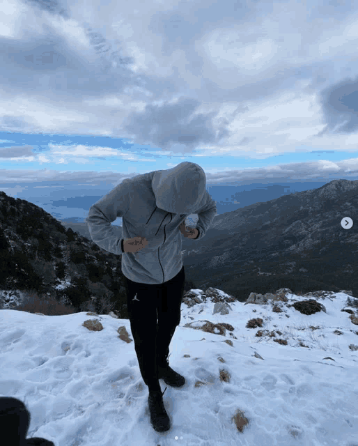a person wearing a grey hoodie with the word air on it