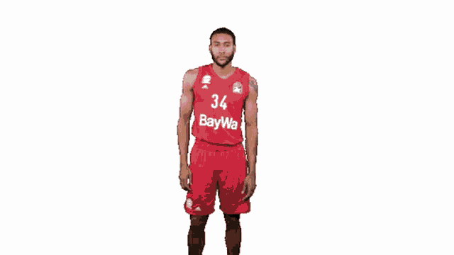 a basketball player with the number 34 on his jersey is standing in front of a white background .