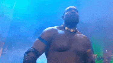 a shirtless man with a necklace around his neck