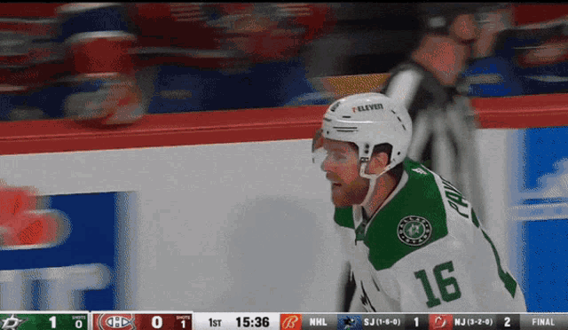 a hockey player wearing a number 16 jersey stands on the ice