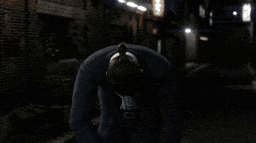 a man in a suit and white shirt is kneeling down