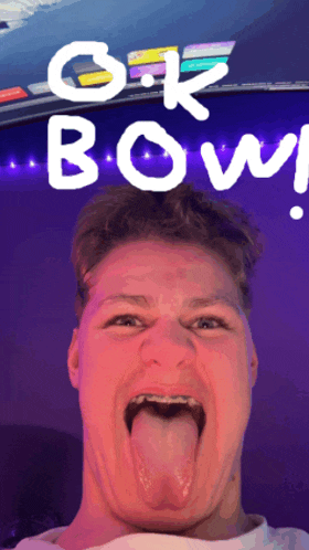 a young man sticking his tongue out in front of a sign that says ok bowl