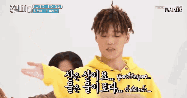 a man in a yellow hoodie talks to another man