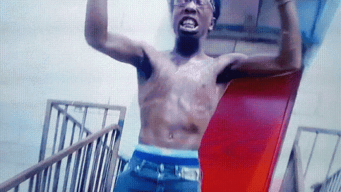 a shirtless man is standing on a staircase with his arms outstretched .