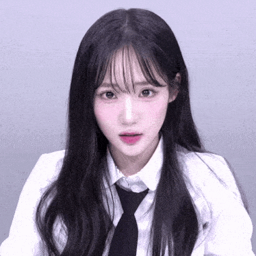 a girl with long black hair is wearing a white shirt and tie