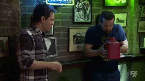 two men are standing in front of a sign that says fx on it