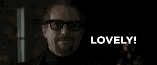 a man wearing glasses and a turtleneck says lovely !