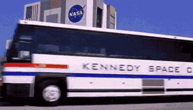 a kennedy space center bus is driving down the road