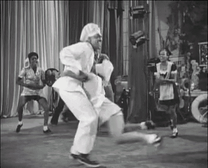 a group of people are dancing on a stage .