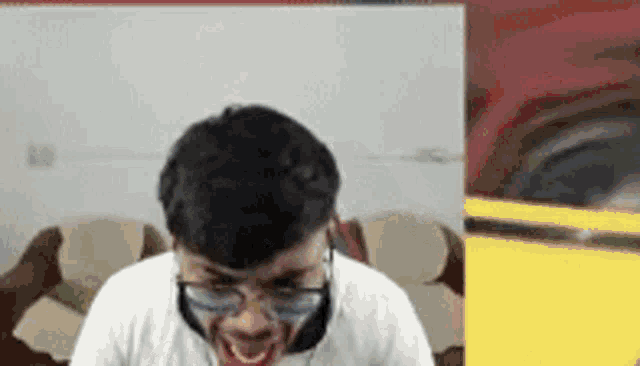 a man wearing glasses is making a funny face .
