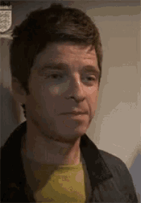 a close up of a man 's face with a yellow shirt on .