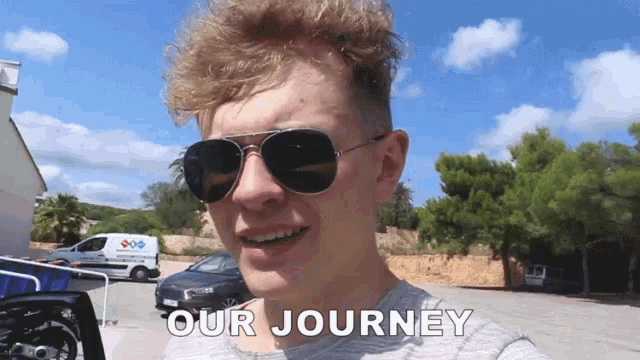 a man wearing sunglasses says " our journey " in front of him