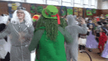 a group of people in costumes are dancing in a room