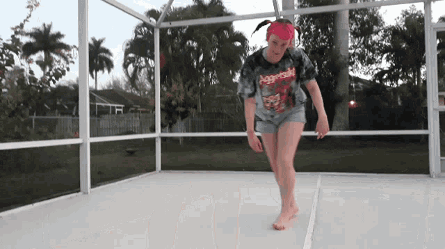 a girl with pink hair is wearing a shirt that says age of the beast