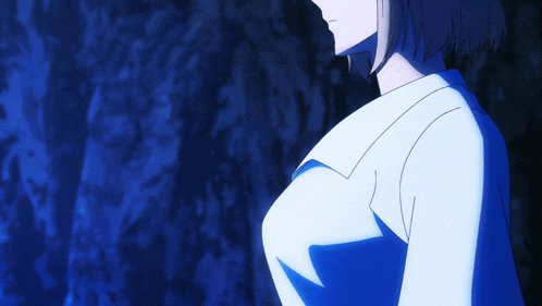 a close up of a woman 's breast in a blue shirt