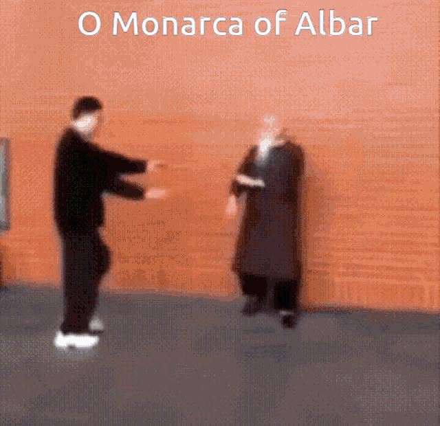 two men are standing in front of a wall with the words o monarcha of albar written above them