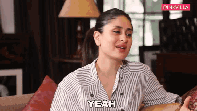 a woman is sitting on a couch and says yeah