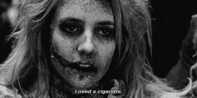 a black and white photo of a zombie girl with a cigarette in her mouth .