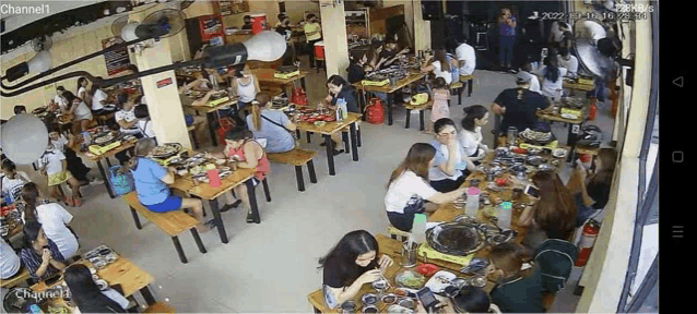a large group of people are sitting at tables in a restaurant called channel1