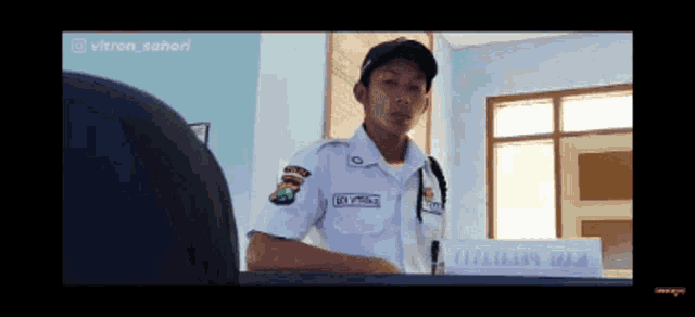a man in a white uniform has the name vitron written on his uniform