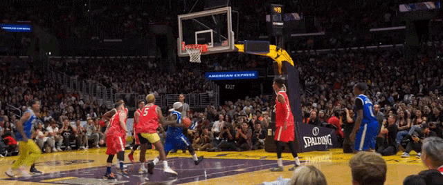 a basketball game is being played in front of a spalding sign