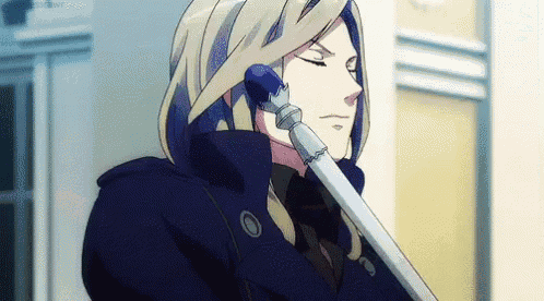 a man with long blonde hair and blue eyes is holding a microphone to his ear .