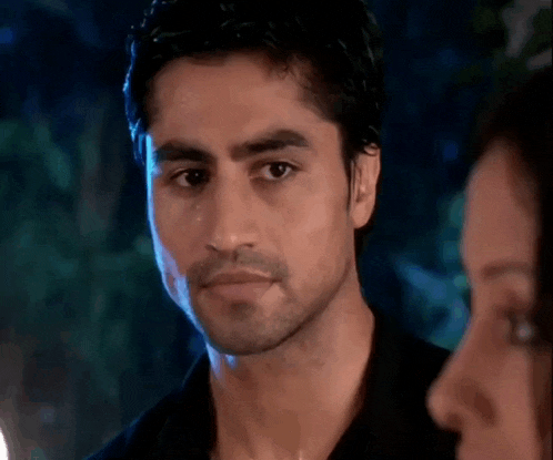 a man in a black shirt is looking at a woman in a black shirt .