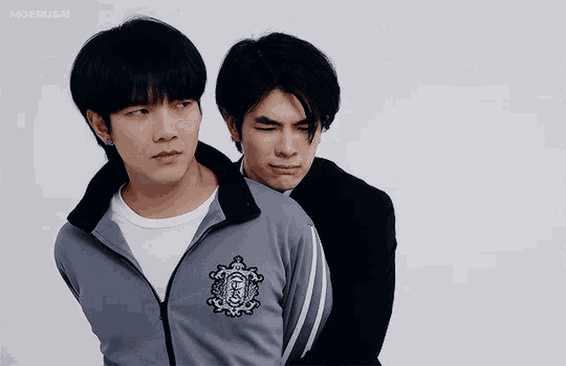 two men are standing next to each other with one wearing a jacket that says moerusai