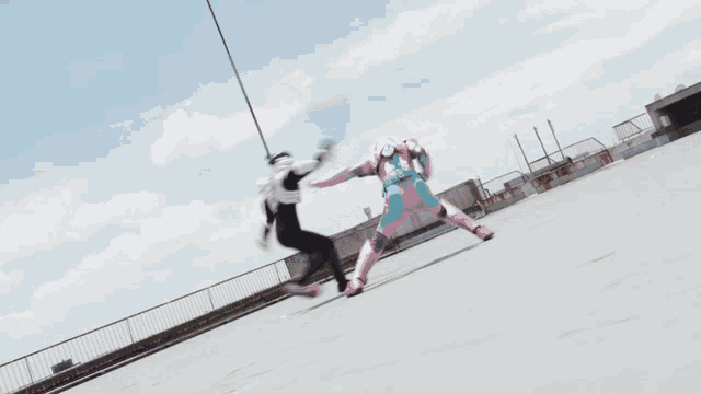 a person in a pink and blue costume is fighting another person