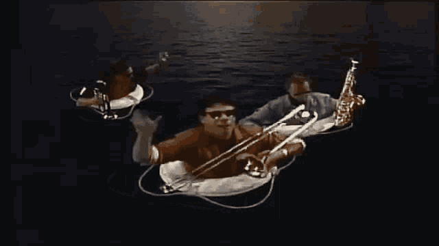 a group of people are floating in the water on life rings
