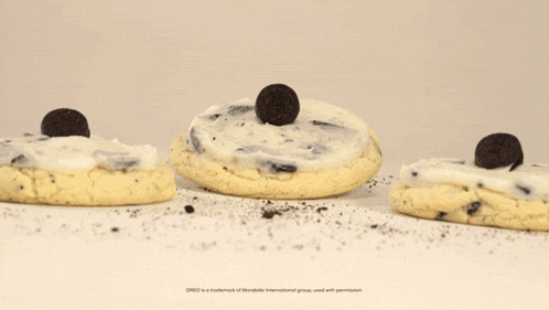 an oreo cookie is sitting on top of a cake
