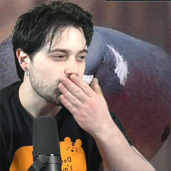 a man covering his mouth with his hand while wearing an orange shirt that says i 'm a dog