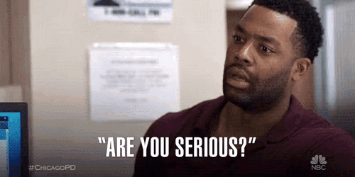 a man with a beard is sitting in front of a computer and saying `` are you serious '' .
