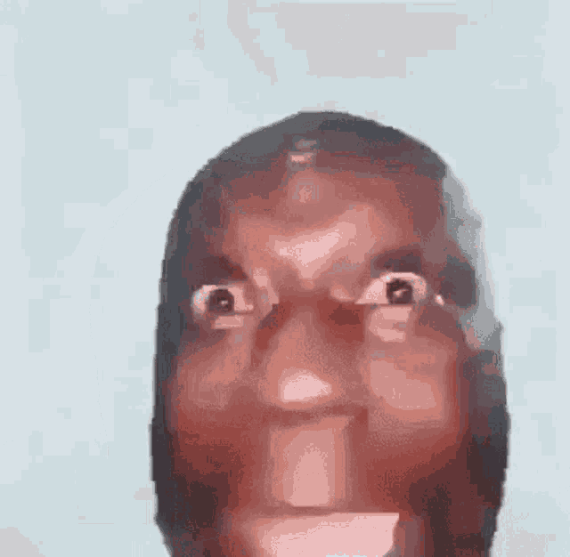 a close up of a man 's face with a very angry expression on his face .