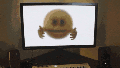 a computer monitor shows a smiley face with arms and eyes