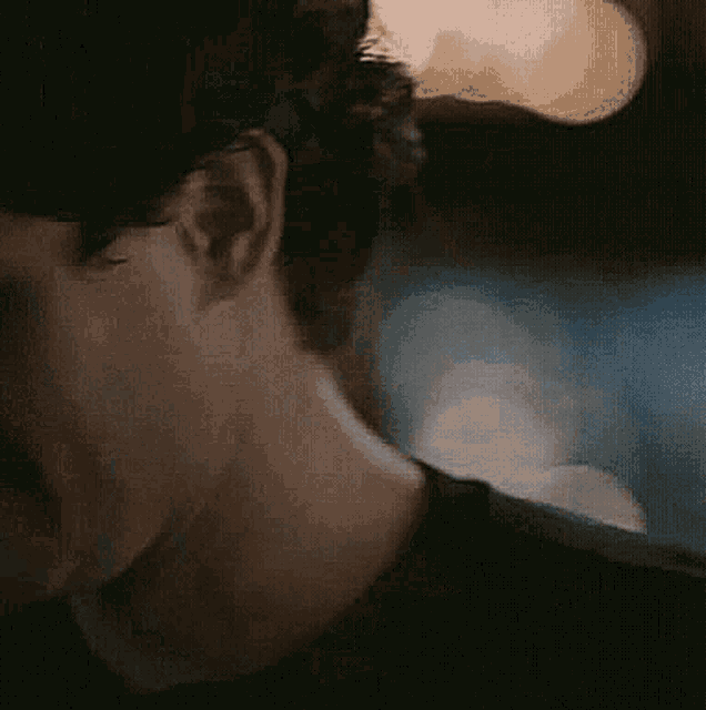 a close up of a man 's neck and ear with a blurry background