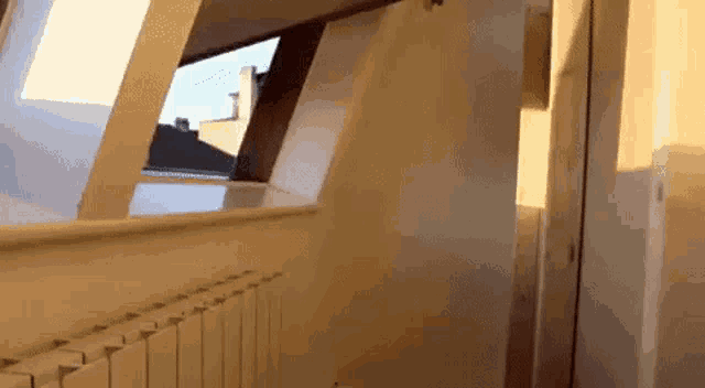 a room with a radiator and a window with a view of a building