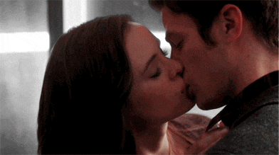 a man and a woman are kissing each other