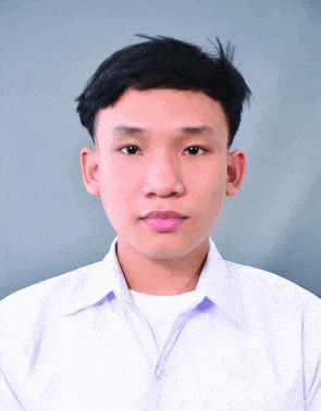 a young man in a white shirt is standing in front of a grey background .